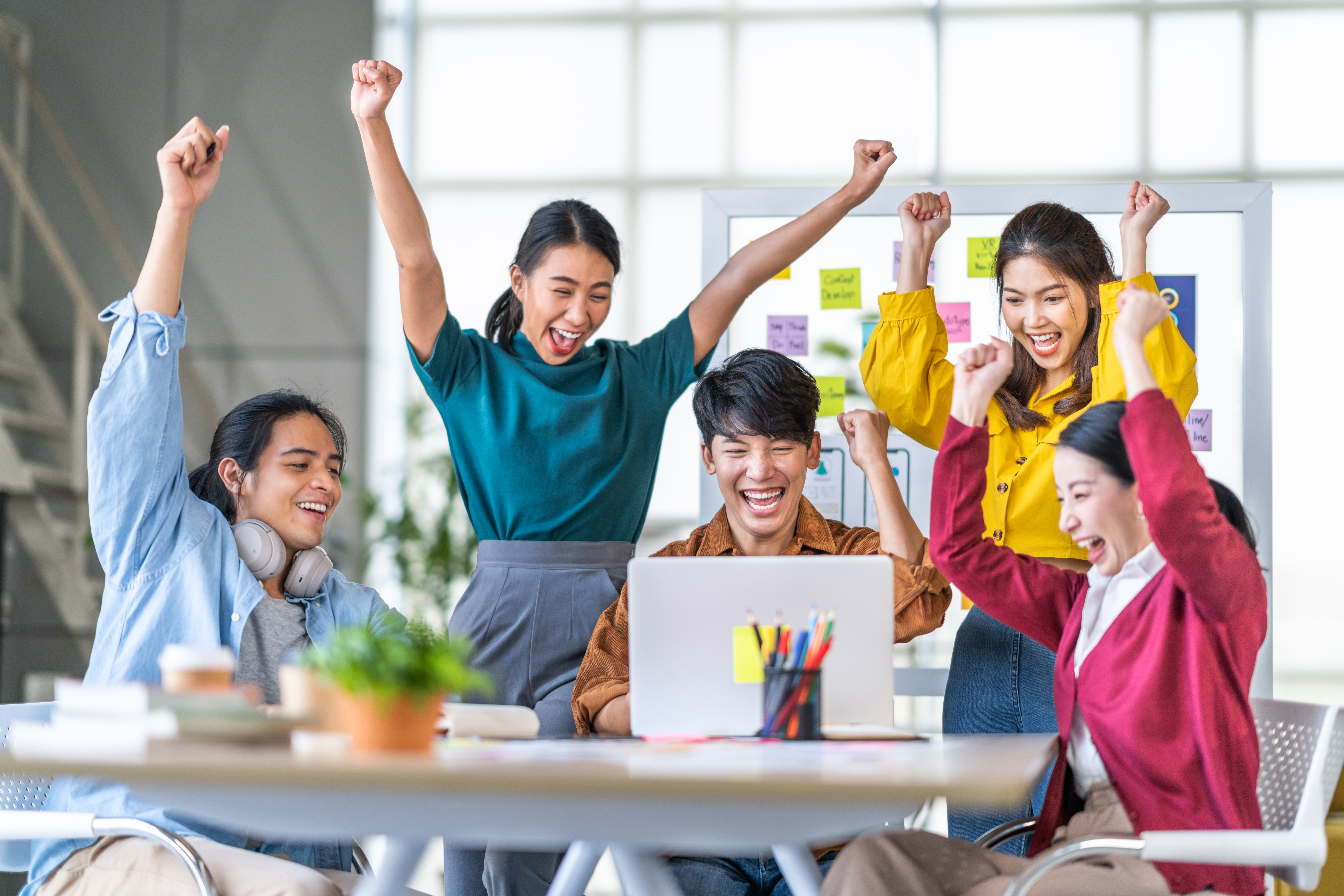 A group of happy professionals celebrating team success.