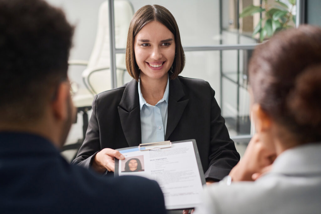 A female job applicant giving her resume in a job interview.